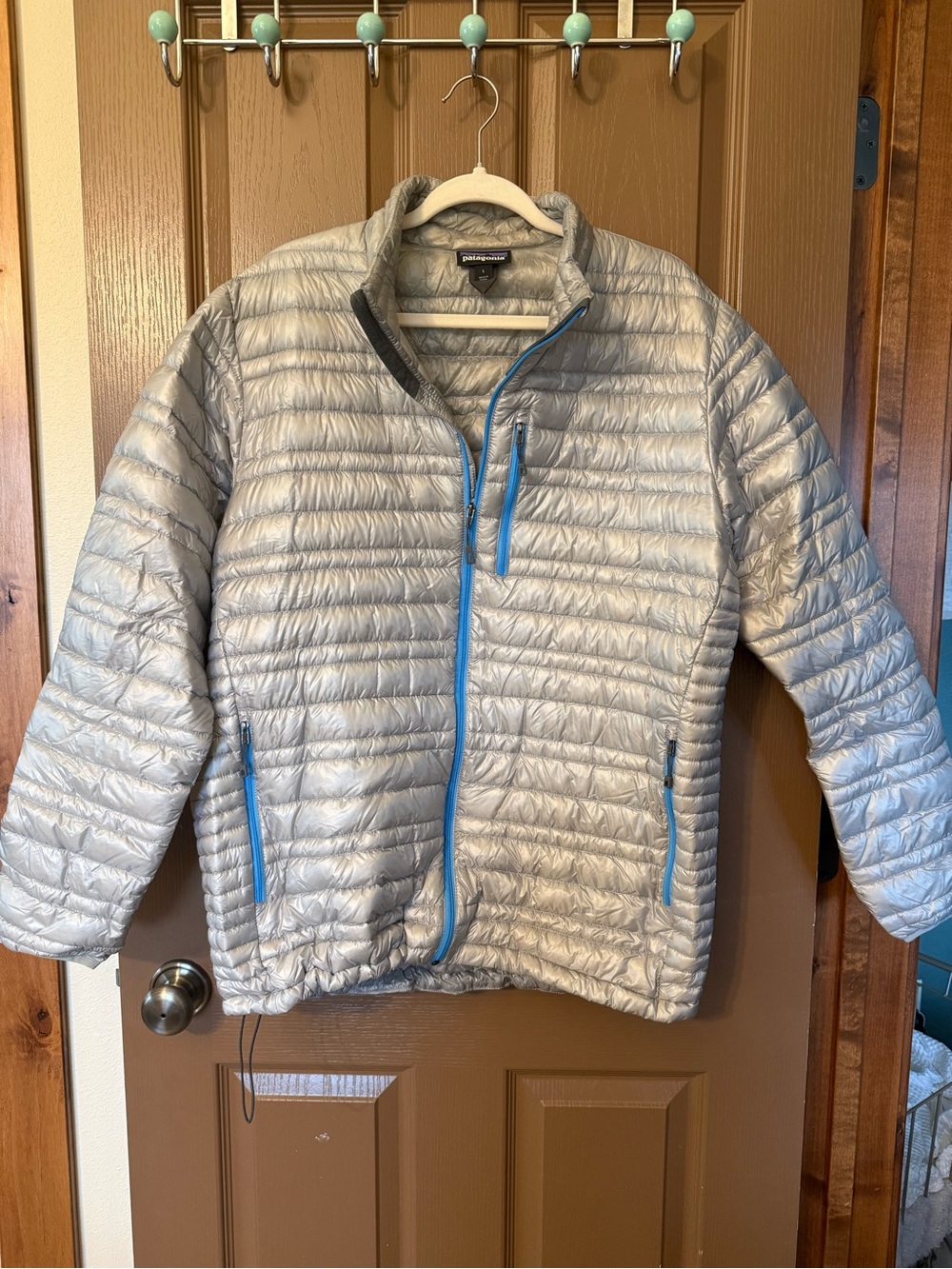 Patagonia Silver Puffer Jacket with Bright Blue Zippers